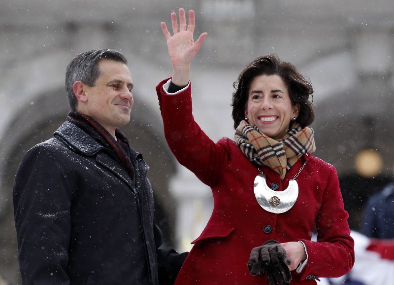 Rhode Island Gov. Gina Raimondo, right, waves to the crowd beside her husband, Andy Moffit, following the gubernatorial inauguration on the steps of the Statehouse in Providence, R.I. CREDIT: AP PHOTO/STEW MILNE, FILE