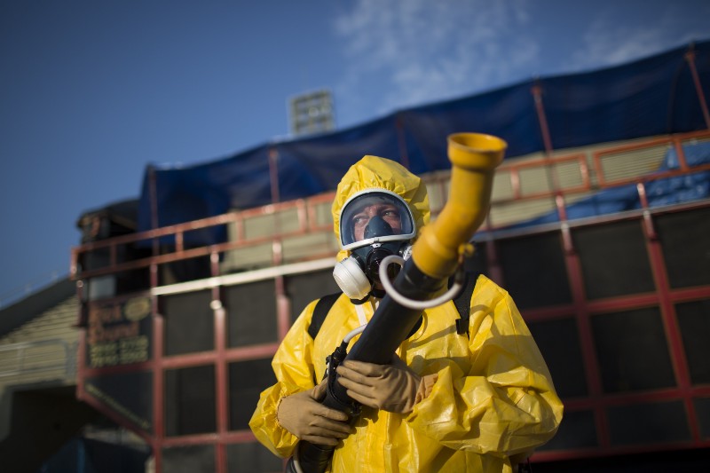A health worker sprays insecticide to combat the Aedes aegypti mosquitoes that transmit the Zika virus, in Rio de Janeiro, Brazil, Tuesday, Jan. 26, 2016. CREDIT: AP PHOTO, LEO CORREA