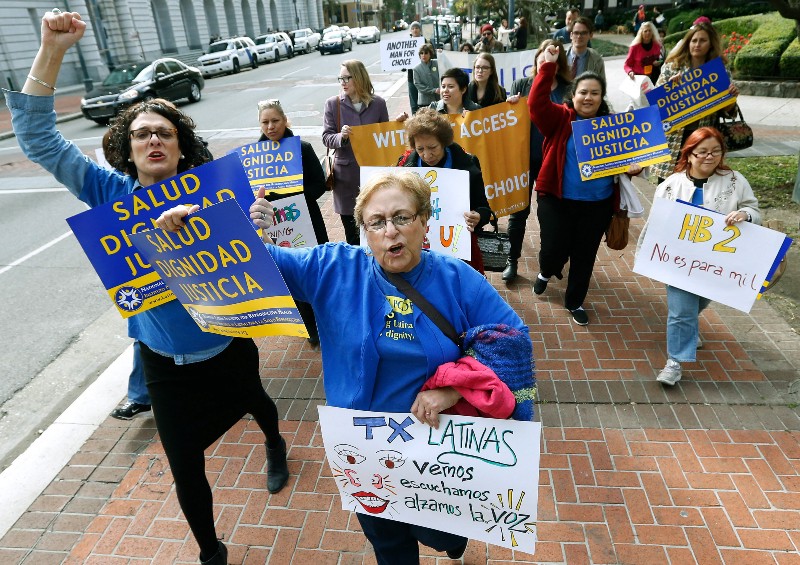 Women with the National Latina Institute for Reproductive Health demonstrate outside of 5th U.S. Circuit Court of Appeals in New Orleans. A federal appeals court in New Orleans is considering whether a Texas law puts up an unconstitutional obstacle to women seeking abortions. CREDIT: AP PHOTO/JONATHAN BACHMAN