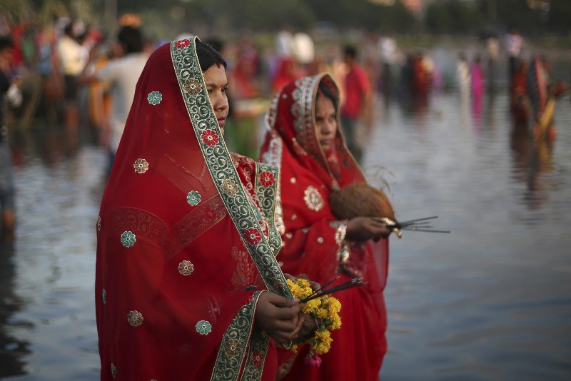 Hindu women perform rituals at sunset to mark Chhath Puja festival in Hyderabad, India on Nov. 17, 2015. CREDIT: AP PHOTO/MAHESH KUMAR A.