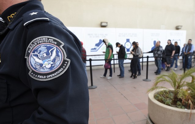 Pedestrians crossing from Mexico into the United States at the Otay Mesa Port of Entry wait in line Thursday, Dec. 10, 2015, in San Diego. (AP Photo/Denis Poroy) CREDIT: AP Photo/Denis Poroy
