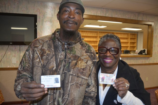 Singletary and Williams display their state ID cards.