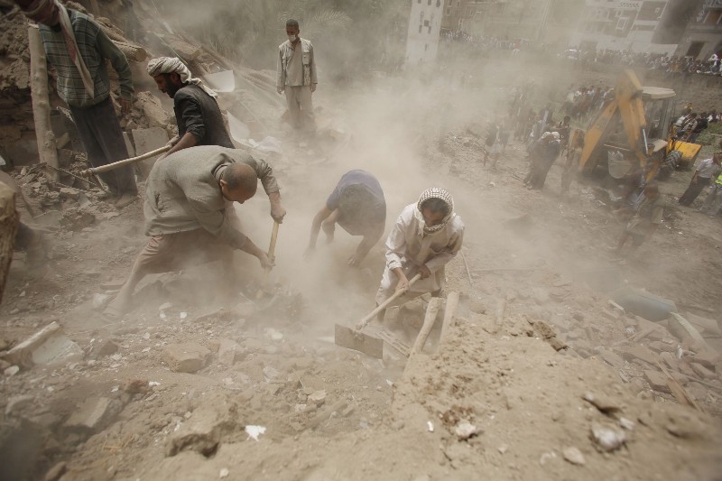 People search for survivors under the rubble of houses destroyed by Saudi airstrikes in the old city of Sanaa, Yemen, Friday, June 12, 2015. CREDIT: AP PHOTO/HANI MOHAMMED
