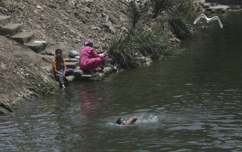 A family wash dishes in Banha, Egypt on June 25, 2011. CREDIT: AP PHOTO/AMR NABIL