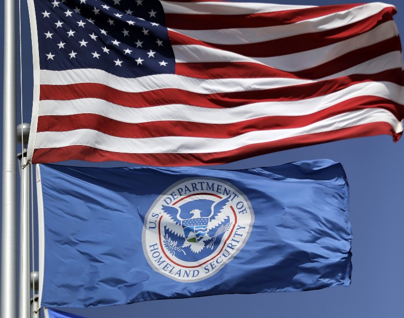 The U.S. and U.S. Department of Homeland Security flags fly over the Karnes County Residential Center in Karnes City, Texas on Thursday, July 31, 2014. Federal officials gave a tour of the South Texas immigration detention facility that has been retooled to house adults with children who have been apprehended at the border. (AP Photo/Eric Gay) CREDIT: AP PHOTO/ERIC GAY