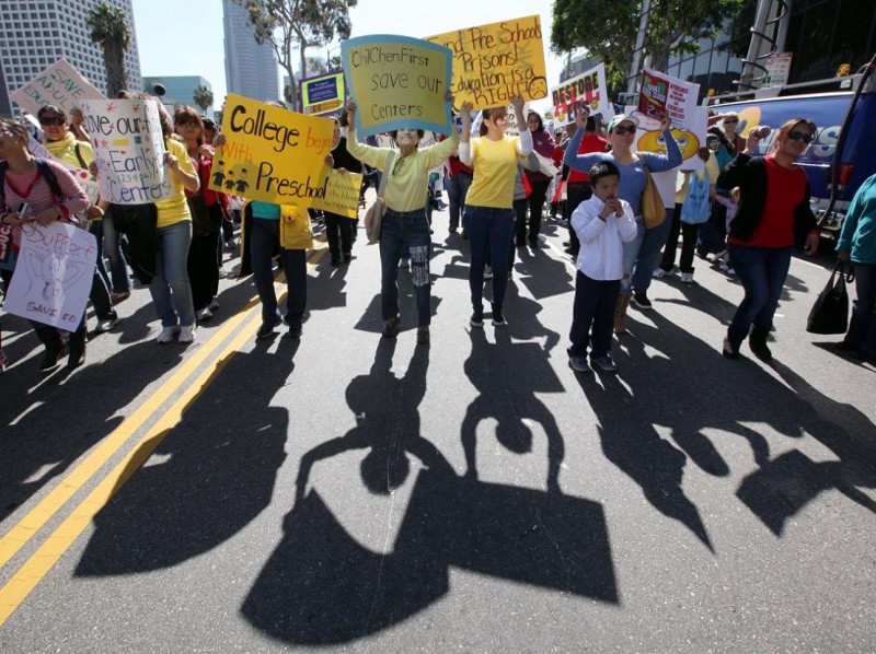 People demonstrate outside the headquarters of the Los Angeles Unified School District, where the Board of Education will determine cuts to the district budget, in downtown Los Angeles Tuesday, March 13, 2012. CREDIT: Reed Saxon, AP