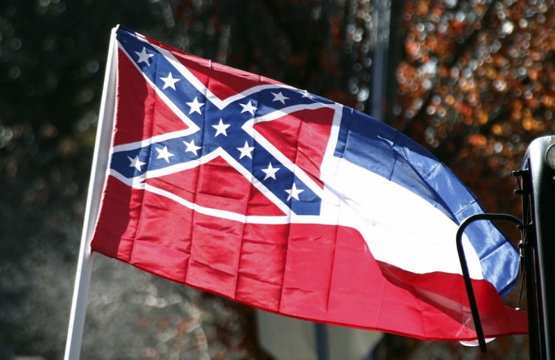 A state flag of Mississippi is unfurled by Sons of Confederate Veterans on January 19, 2016. CREDIT: Rogelio V. Solis, AP