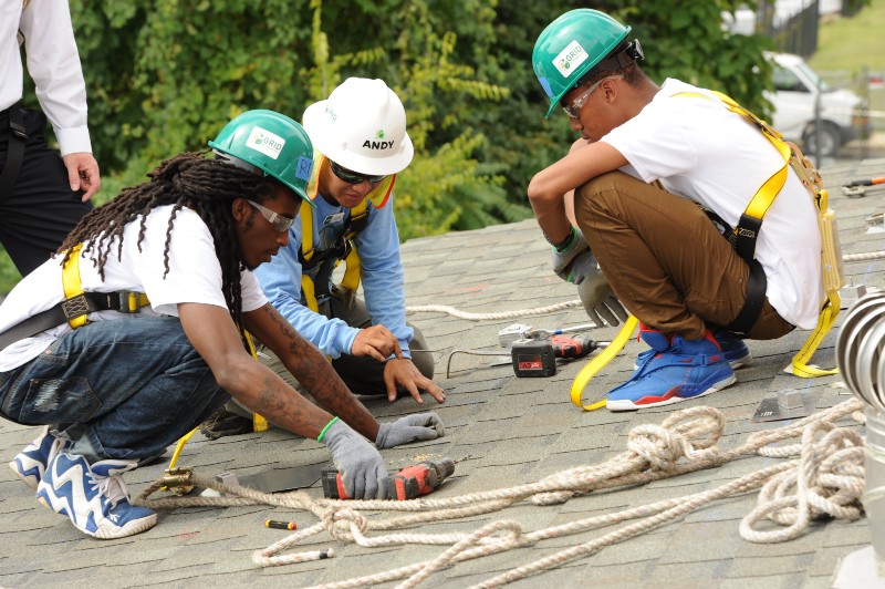Volunteers and GRID Alternative staff get ready to install solar on a low-income home. CREDIT: COURTESY GRID ALTERNATIVES