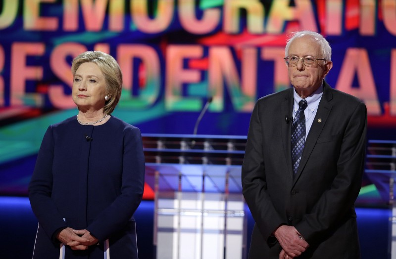 Democratic presidential candidates Hillary Clinton, left, and Sen. Bernie Sanders, I-Vt., stand on stage before a Democratic presidential primary debate at the University of Michigan-Flint. CREDIT: AP PHOTO/CHARLIE NEIBERGALL