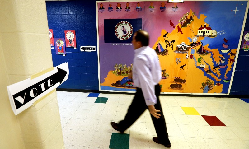 A voter heads to cast his ballot during the presidential primary in Henrico, Va., Tuesday, March 1, 2016. CREDIT: AP PHOTO/STEVE HELBER