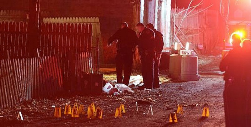Investigators at the scene of Wednesday’s mass shooting in Wilkinsburg. CREDIT: AP PHOTO/MICHAEL HENNINGER