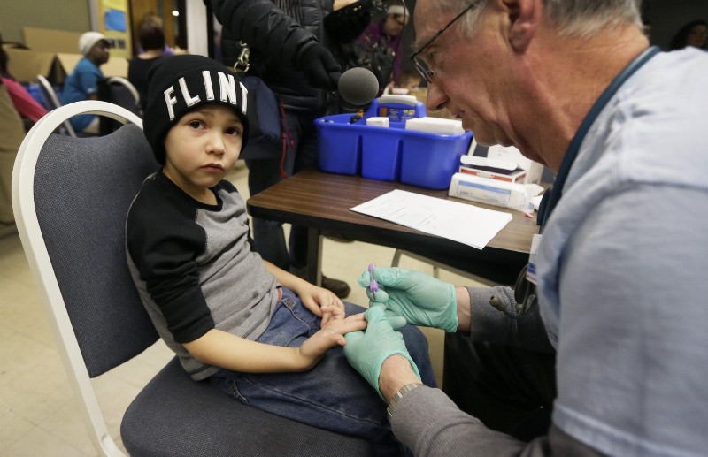 Registered Nurse Brian Jones draws a blood sample from Grayling Stefek, 5, at the Eisenhower Elementary School, Tuesday, Jan. 26, 2016 in Flint, Mich.AP Photo/Carlos CREDIT: AP PHOTO, CARLOSĀ OSORIO