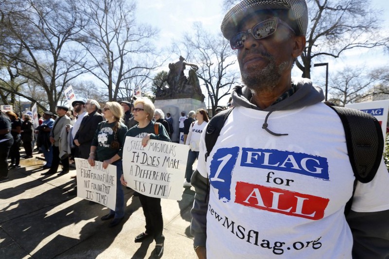 Milton Phelps stands with Maureen Phillips and her sister Dixie Daniels in calling for a change to the current Mississippi state flag in Jackson, Miss. CREDIT: Rogelio V. Solis, AP