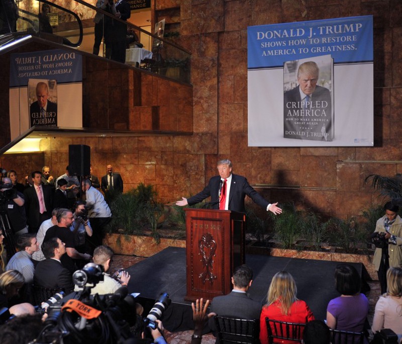 Donald Trump giving a press conference in the Trump Tower atrium in November 2015. The pink marble is visible in the background. CREDIT: RTNStevens/MediaPunch/IPX