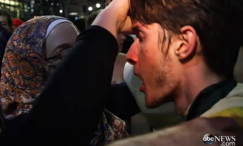 A woman pours milk into a man’s eyes after cops pepper sprayed them outside a Donald Trump rally on Saturday. CREDIT: ABC NEWS SCREENSHOT