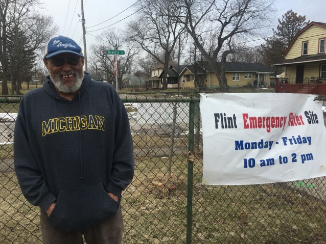 Pastor Bobby Jackson hands out water to homeless and low-income Flint residents. CREDIT: Kira Lerner