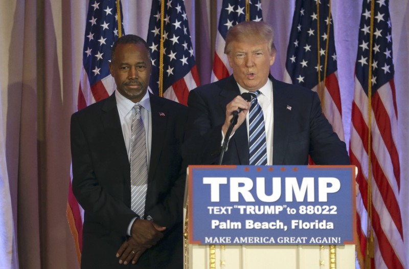 Former Republican presidential candidate Ben Carson listens at left, before announcing he will endorse Republican presidential candidate Donald Trump CREDIT: AP PHOTO/LYNNE SLADKY