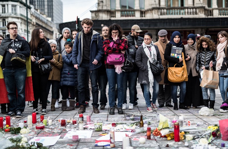 People gather at a memorial for victims of attacks in Brussels on Wednesday, March 23, 2016. CREDIT: AP PHOTO/VALENTIN BIANCHI