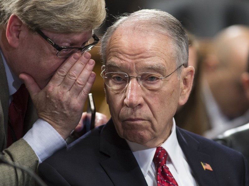 Senate Judiciary Committee Chairman Sen. Charles Grassley, R-IA) listens to an aide as Republicans and Democrats remain at an impasse over filling the Supreme Court vacancy CREDIT: AP PHOTO/J. SCOTT APPLEWHITE