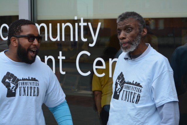 John Comer helps Reggie Smith celebrate after voting for the first time in decades. CREDIT: Kira Lerner