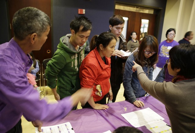 In this photo,, applicants are given instructions how to check in for a health care enrollment event at the Oakland Asian Cultural Center in Oakland, Calif CREDIT: AP Photo/Eric Risberg