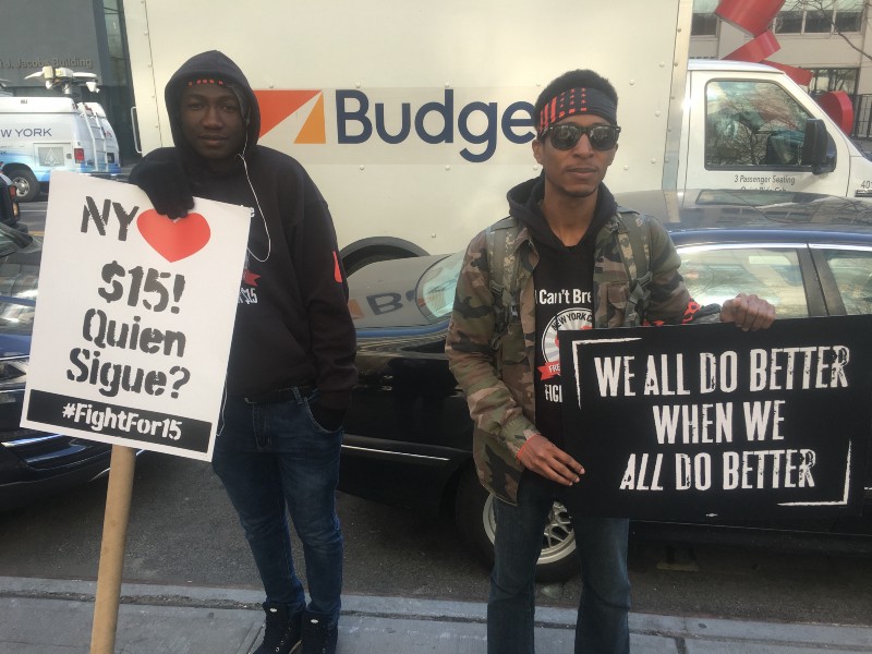 Anthony Plummer (right) protesting for a $15 minimum wage and to demand justice for Akai Gurley’s death. CREDIT: KIRA LERNER