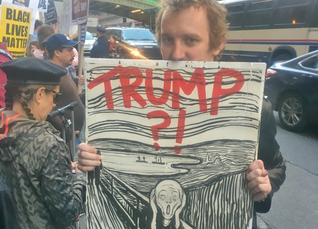 Chris Nye, from Brooklyn, said his sign represents “existential dread” from Trump. CREDIT: Kira Lerner