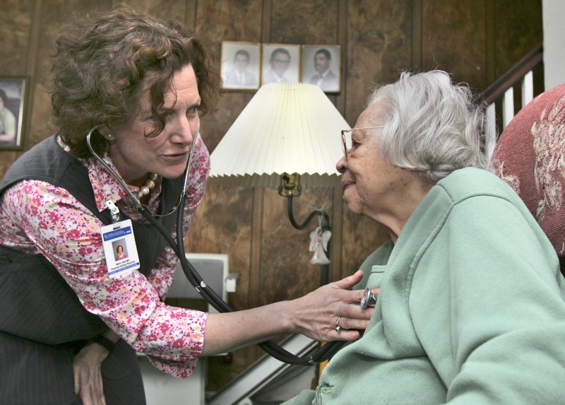 A doctor makes a house call to a Medicare patient in her Philadelphia home. Medicare is the government program that provides coverage for Americans over the age of 64. CREDIT: AP PHOTO/RUSTY KENNEDY