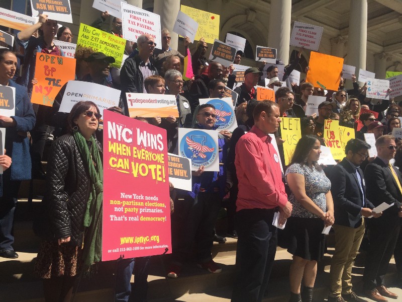 New Yorkers rally outside city hall asking for open primaries so independents can participate in Tuesday’s presidential primary election. CREDIT: EMILY ATKIN