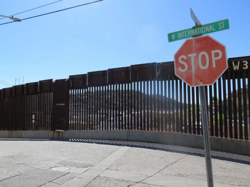 This Wednesday, March 9, 2016 photo shows a stop sign in front of the international border fence in Nogales, Ariz. Residents of this border neighborhood say presidential candidate Donald Trump’s idea to build a wall between Mexico and the United States is absurd. CREDIT: AP PHOTO/ASTRID GALVAN