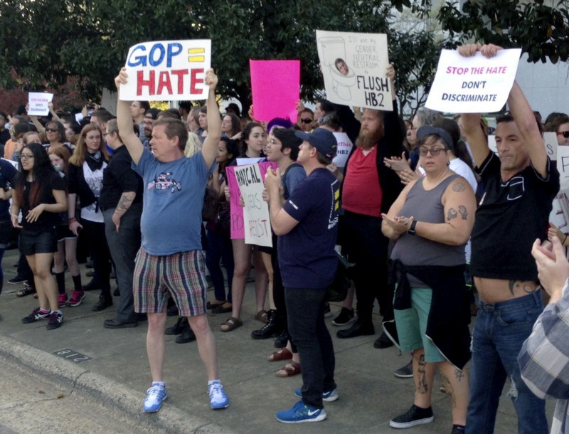 People protest outside the North Carolina Executive Mansion in Raleigh, N.C., Thursday, March 24, 2016 CREDIT: AP PHOTO/EMERY P. DALESIO