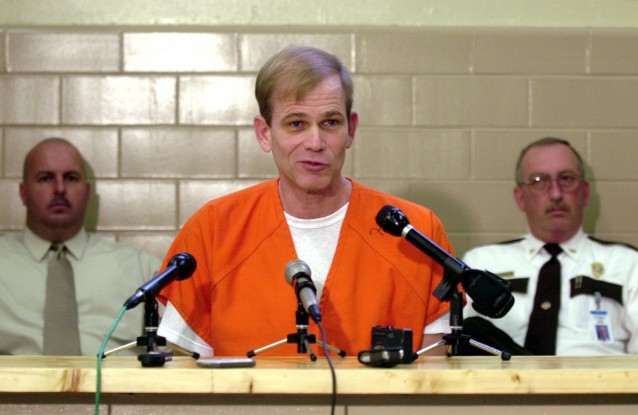 In this Sept. 2, 2003 file photo, Paul Hill, center, talks to the media at the state prison in Starke, Florida. CREDIT: AP Photo/Peter Cosgrove, File
