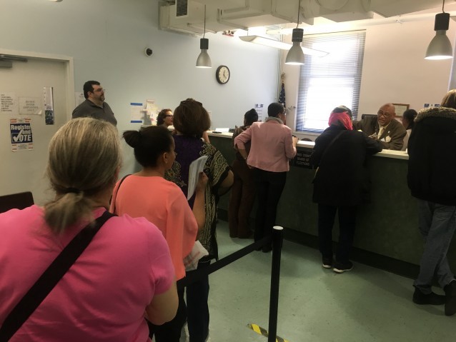 Voters line up to speak with employees at the Kings County Board of Elections office. CREDIT: Kira Lerner