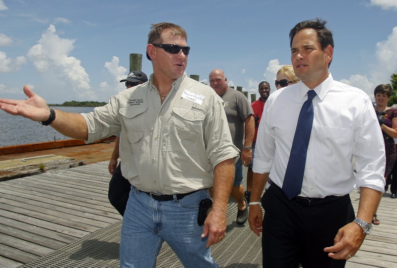 Shannon Hartsfield, president of the Franklin County Seafood Workers Association, left, discusses his industry’s water issues with U.S. Sen. Marco Rubio, Tuesday, Aug. 13, 2013, in Apalachicola, Florida, on the other side of the state from Biscayne National Park. CREDIT: AP PHOTO/PHIL SEARS