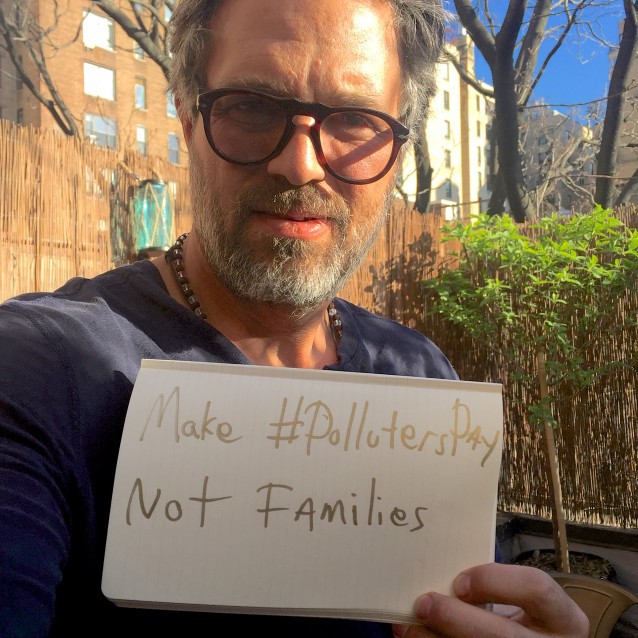 Mark Ruffalo holds a sign promoting #polluterspay CREDIT: Green For All