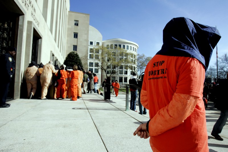 David Barrows, right, of Washington, and other members of a group calling themselves “Witness Against Torture”, protest the U.S. Navy’s detention center at Guantanamo Bay, Cuba, Thursday, Jan. 11, 2007, in front of E. Barrett Prettyman U.S. Federal Court House in Washington. CREDIT: AP PHOTO/CALEB JONES