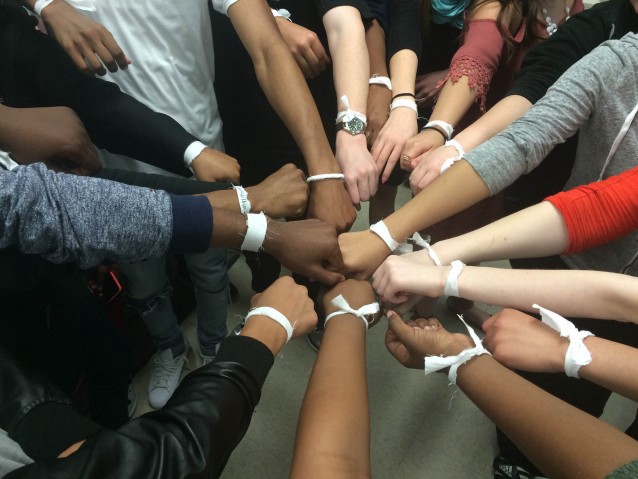 Riverside High School students distributed white strips of cloth as armbands to show solidarity after their schoolmate Wildin Acosta was detained. CREDIT: Ellen Holmes