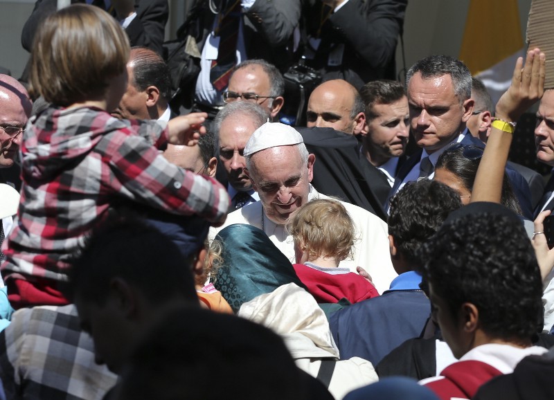 Pope Francis meets migrants at the Moria refugee camp on the Greek island of Lesbos, Saturday April 16, 2016. CREDIT: AP PHOTO/PETROS GIANNAKOURIS
