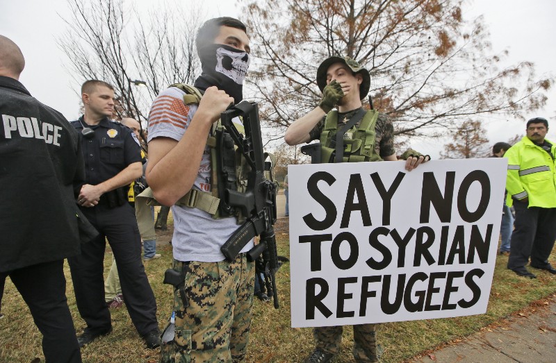 Armed anti-Muslim protestors stand across the street from a mosque during a demonstration in Richardson, Texas, on Saturday, Dec. 12, 2015. CREDIT: AP PHOTO/LM OTERO