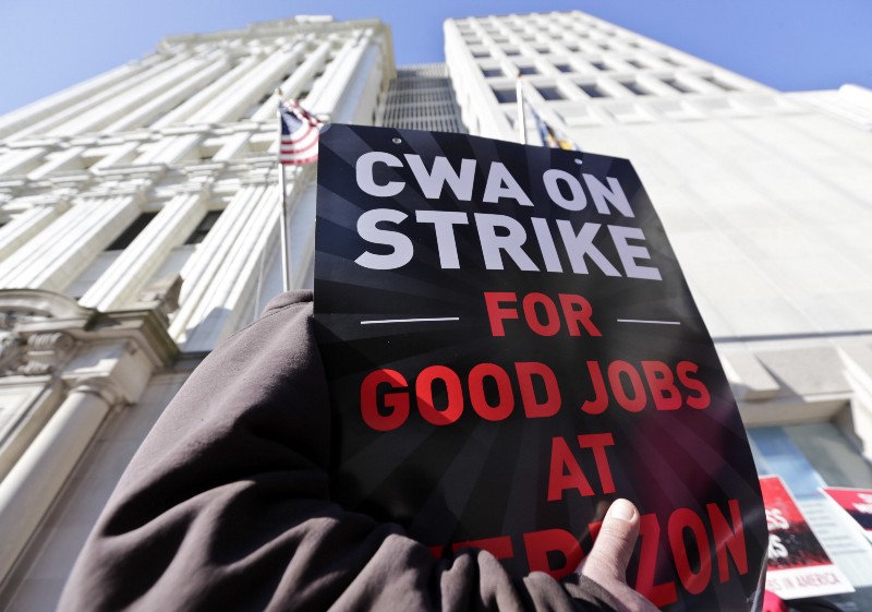 Striking Verizon workers picket outside a Verizon office on after cable workers on the East Coast walked off the job Wednesday morning CREDIT: AP PHOTO/MIKE GROLL