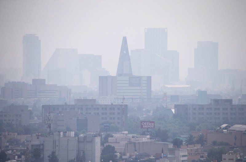 Smog blankets skyscrapers along Paseo de la Reforma in Mexico City, Thursday, March 17, 2016. An air pollution alert in greater Mexico City was extended to its fourth day, with authorities saying that despite slight improvements smog levels remained at almost 1 1/2 times acceptable limits in some areas. CREDIT: AP Photo/Rebecca Blackwell