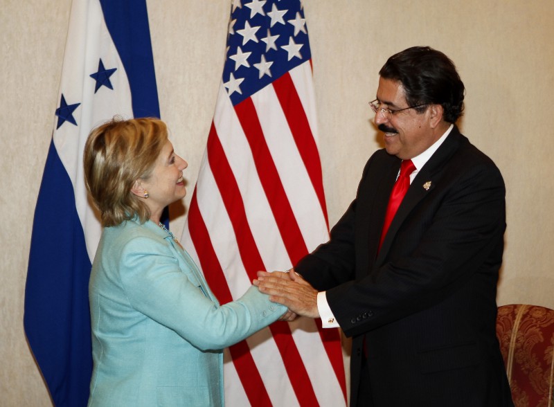 U.S. Secretary of State Hillary Clinton, left, shakes hands with Honduras’ President Manuel Zelaya during the 39th General Assembly of the Organization of American States, OAS, in San Pedro Sula, Honduras, Tuesday, June 2, 2009. CREDIT: AP PHOTO/EDUARDO VERDUGO
