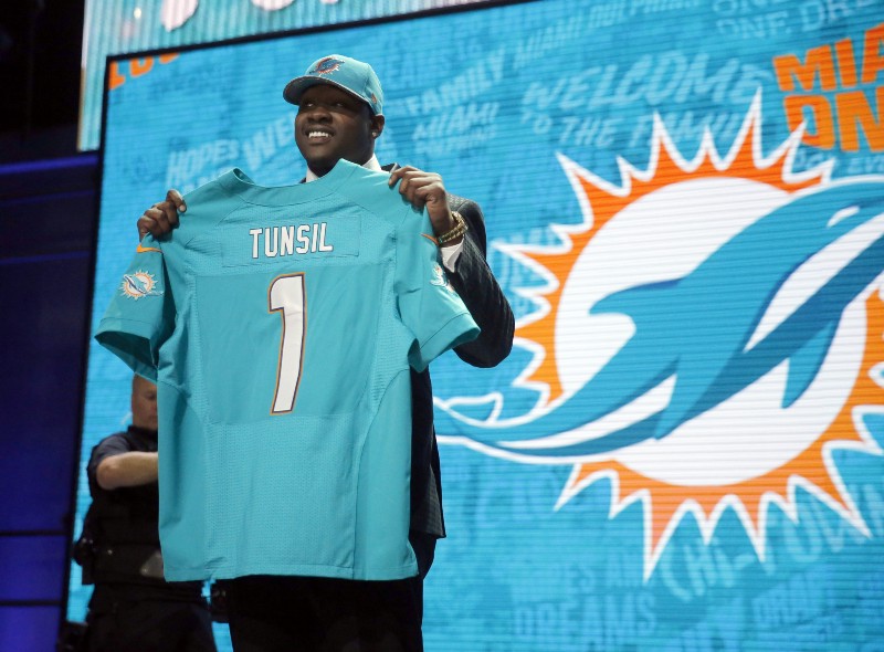 Mississippis Laremy Tunsil poses for photos after being selected by the Miami Dolphins as the 13th pick in the first round of the 2016 NFL football draft, Thursday, April 28, 2016, in Chicago. CREDIT: CHARLES REX ARBOGAST, AP