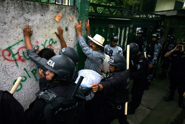 Farmers who support Honduras’ ousted President Manuel Zelaya are detained by riot police in Tegucigalpa, Wednesday, Sept 30, 2009. CREDIT: AP Photo/Rodrigo Abdo