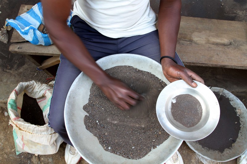 In this photo taken Aug. 16, 2012, a Congolese miner sifts through ground rocks to separate out the cassiterite, in the town of Nyabibwe, eastern Congo, a once bustling outpost fueled by artisanal cassiterite mining. Gold is now the primary source of income for armed groups in eastern Congo, and is ending up in jewelry stores across the world, according to a report published Thursday, Oct. 25, 2012, by the Enough Project. CREDIT: AP PHOTO/MARC HOFER