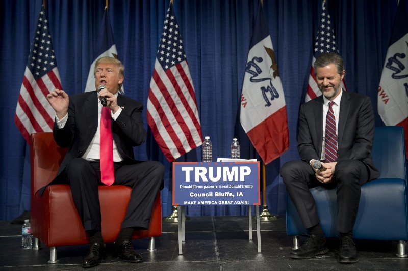 Jerry Falwell Jr., president of Liberty University, smiles as he listens to Republican presidential candidate Donald Trump, left, at a rally in January. CREDIT: AP PHOTO/JAE C. HONG
