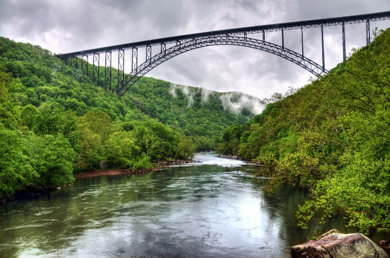 View of the New River bridge in Fayette County, West Virginia. Wolf Creek, a tributary of the New River, has traces of fracking waste chemicals that are affecting the local ecosystem, according to a new study. Researchers discovered the chemicals near a fracking fluid waste site. The New River is a local water source. CREDIT: BILL DICKINSON/FLICKR