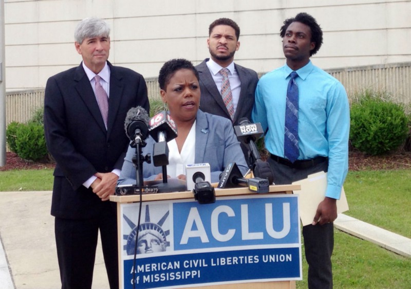 Jennifer Riley-Collins, executive director of the American Civil Liberties Union of Mississippi, introduces the lawsuit, flanked by attorney Oliver Diaz, and plaintiffs Nykolas Alford and Stephen Thomas. CREDIT: AP PHOTO/EMILY WAGSTER PETTUS