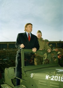 Donald Trump stands in an Army staff car at Floyd Bennett Field in the Brooklyn borough of New York, during the staging of various military vehicles for the Nation’s Parade, Nov. 10, 1995. CREDIT: AP Photo/Ed Bailey
