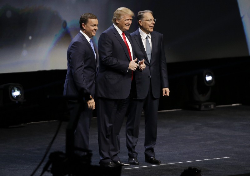 Republican presidential candidate Donald Trump with National Rifle Association executive director Chris W. Cox , left, and NRA executive vice president Wayne LaPierre, right. CREDIT: (AP PHOTO/MARK HUMPHREY)